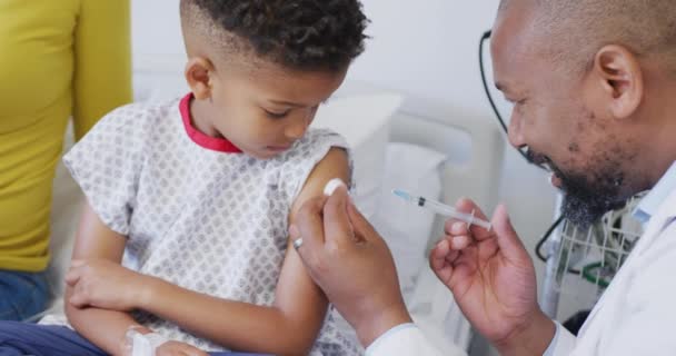 Αφροαμερικανός Γιατρός Που Εμβολιάζει Παιδί Ασθενή Στο Νοσοκομείο Ιατρική Υγειονομική — Αρχείο Βίντεο
