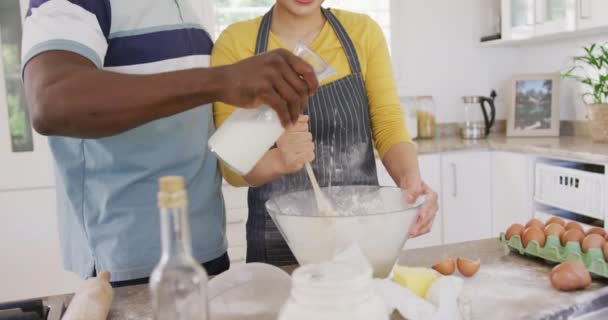 Happy Diverse Couple Wearing Aprons Baking Kitchen Spending Quality Time — Vídeos de Stock