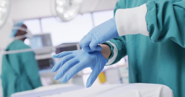 Video Midsection Surgeon Putting Surgical Gloves Operating Theatre Hospital Medical — Vídeo de Stock