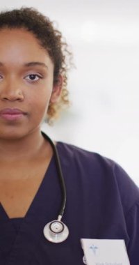 Vertical video of portrait of happy african american female doctor. Global medicine, health, lifestyle and hospital concept.
