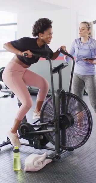 Vertical Video Diverse Female Fitness Trainer Woman Exercise Bike Working — Stock Video