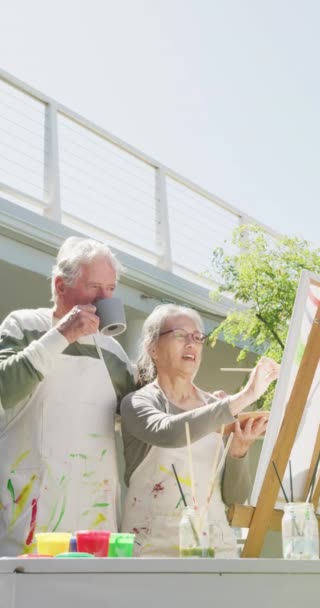Vertical Video Happy Diverse Senior Couple Painting Garden Sunny Day — Vídeo de stock