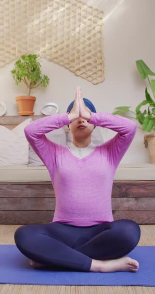 Vertical Video Tranquil Biracial Woman Hijab Sitting Yoga Meditation Pose — Stok video