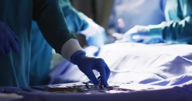 Video of midsection of surgical assistant preparing instruments for during operation, copy space. Hospital, medical and healthcare services.