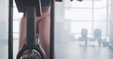 Video of determined african american woman on exercise bike working out at a gym. Exercise, fitness and healthy lifestyle.