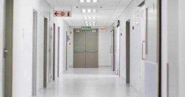 Video of brightly lit, clean, empty corridor in modern hospital, with copy space. Hospital, medical and healthcare services.