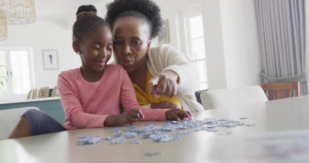Happy African American Granddaughter Grandmother Doing Jigsaw Puzzle Home Copy — 图库视频影像