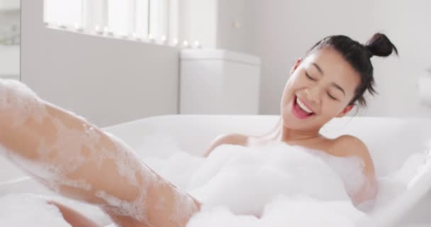 Video Portrait Smiling Biracial Woman Sitting Bathtub Bubble Bath Bathroom — Stok video