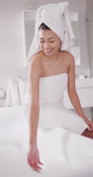 Vertical Video Smiling Biracial Woman Towel Hair Sitting Bathtub Bathroom — 비디오