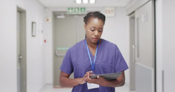 Video African American Female Doctor Walking Busy Hospital Corridor Using — Vídeo de Stock