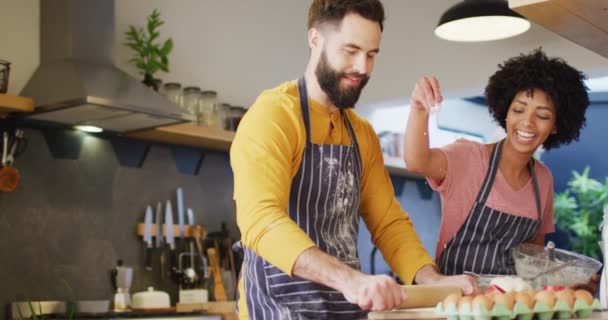 Video Happy Diverse Couple Aprons Talking Baking Together Kitchen Copy — Stockvideo