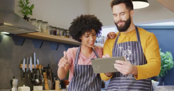 Video Happy Diverse Couple Aprons Using Tablet Baking Together Kitchen — Stok video
