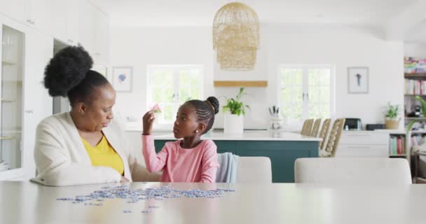 Happy African American Granddaughter Grandmother Doing Jigsaw Puzzle Home Copy — Stockvideo