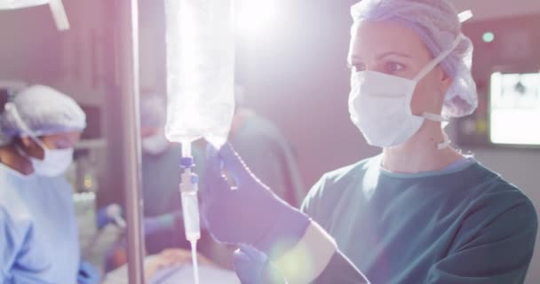 Video Caucasian Female Surgical Assistant Preparing Drip Bag Operating Theatre — Stockvideo