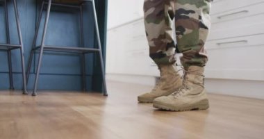 Low section of african american father and his son dancing togehter in kitchen. Spending quality time at home.