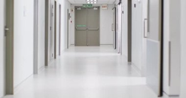 Video of brightly lit, clean, empty corridor in modern hospital, with copy space. Hospital, medical and healthcare services.