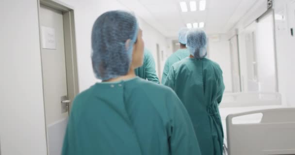 Rear View Group Diverse Surgeons Surgical Caps Gowns Walking Hospital — Stock videók