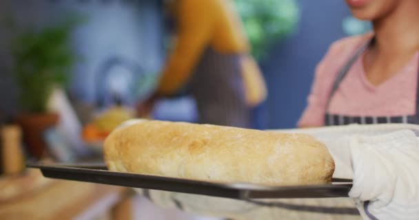 Video Happy Diverse Couple Baking Woman Taking Bread Out Oven — Vídeos de Stock