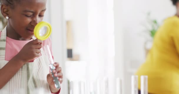 Excited African American Girl Looking Test Tube Magnifying Glass Home — Αρχείο Βίντεο