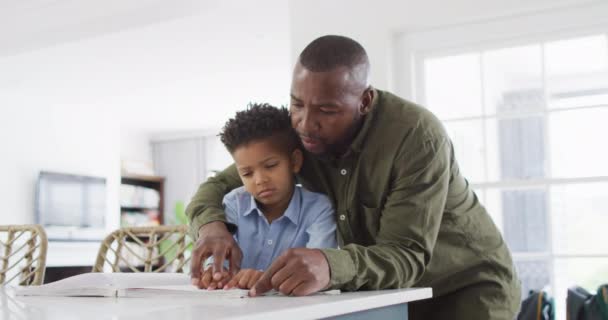 Happy African American Man His Son Sitting Table Reading Braille — Stock Video