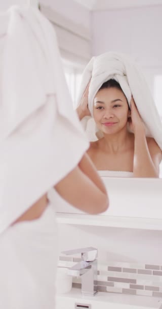 Vertical Video Smiling Biracial Woman Towel Hair Looking Mirror Bathroom — 비디오