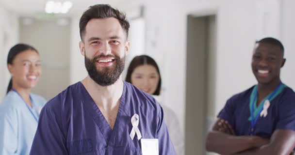 Video Portrait Happy Caucasian Male Doctor Cancer Ribbon Hospital Corridor — Stockvideo