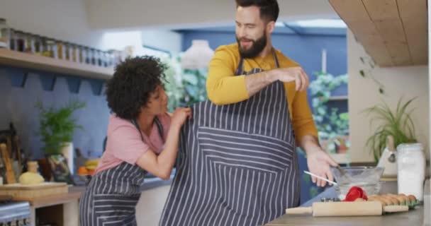 Video Happy Diverse Couple Putting Aprons Preparing Food Kitchen Home — Video