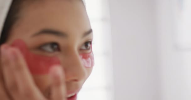 Video Portrait Smiling Biracial Woman Towel Hair Applying Eye Mask — Vídeo de Stock