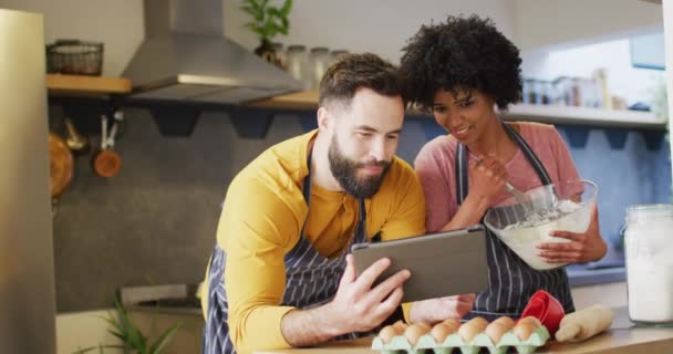 Video Happy Diverse Couple Aprons Using Tablet Baking Together Kitchen — Video