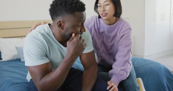 Sad Diverse Couple Sitting Couch Talking Bedroom Spending Quality Time — Wideo stockowe