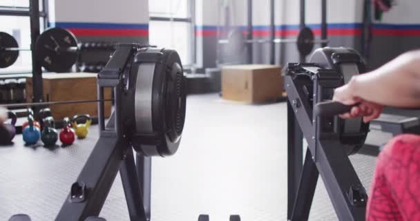 Video Rear View Two Diverse Women Rowing Machines Working Out — Stock videók