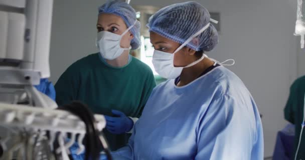 Video Two Diverse Female Surgical Assistants Preparing Electronic Equipment Operating — Stockvideo