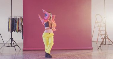 Portrait of happy caucasian female dancer dancing in dance studio, slow motion. Hobby, art and dance studio concept.