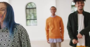 Happy diverse male and female dancers dancing in dance studio, slow motion. Hobby, art and dance studio concept.