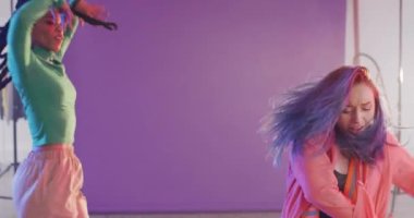 Portrait of happy diverse female dancers dancing in dance studio, slow motion. Hobby, art and dance studio concept.