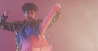 Portrait of happy diverse male and female dancers dancing in dance studio, slow motion. Hobby, art and dance studio concept.