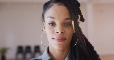 Portrait of happy biracial woman looking at camera in dance studio, slow motion. Hobby, art and dance studio concept.