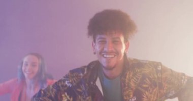 Portrait of happy diverse male and female dancers dancing in dance studio, slow motion. Hobby, art and dance studio concept.