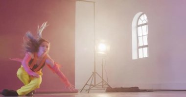 Happy caucasian female dancer dancing alone in dance studio, slow motion. Hobby, art and dance studio concept.