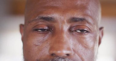 Portrait of happy senior african american man spending time in log cabin, slow motion. Free time, domestic life and leisure concept.