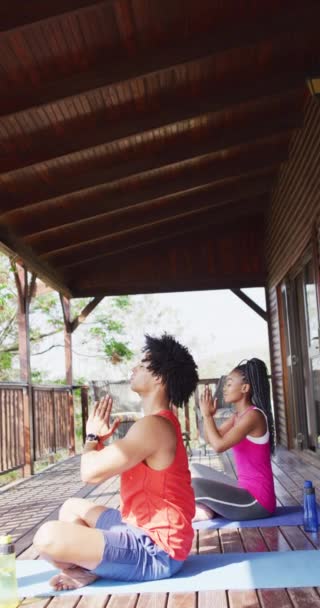 Vertical Video African American Couple Doing Yoga Log Cabin Free — Video Stock
