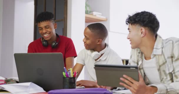 Three Happy Diverse Male Teenage Friends Using Laptop Tablet Home — Video