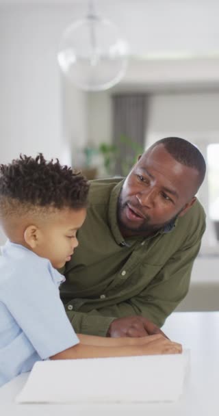 Vertical Video African American Man His Son Sitting Table Reading — Stock videók