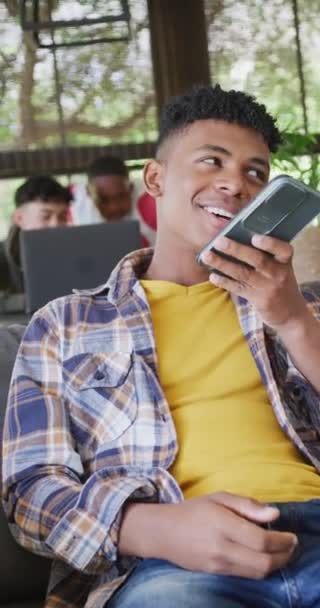 Vertical Video Happy Diverse Male Teenage Friends Using Smartphone Spending — Vídeos de Stock