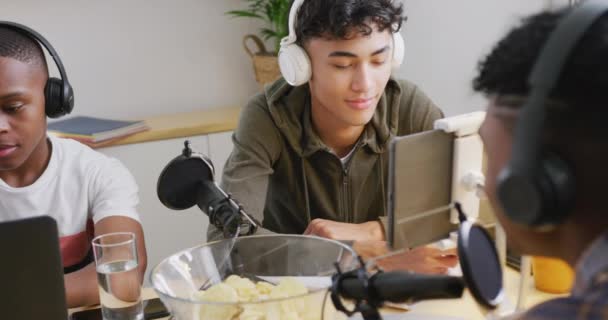 Happy Diverse Male Teenage Friends Using Laptop Recording Podcast Slow — стоковое видео