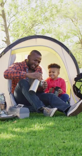 Vertical Video African American Man His Son Sitting Tent Garden — Stock Video