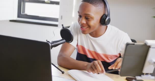 Happy African American Male Teenage Boy Recording Podcast Using Laptop — 비디오