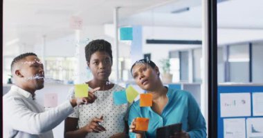 African american business people brainstorming and using tablet at office, slow motion. Working at office, business concept.