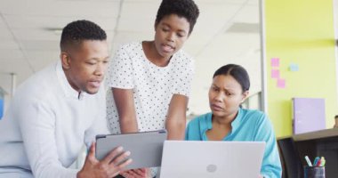 African american business people having meeting and using laptop at office, slow motion. Working at office, business concept.