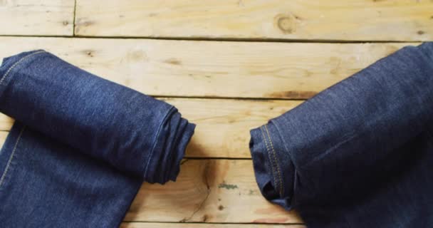 Video Two Pairs Rolled Denim Trousers Copy Space Wooden Background — Stockvideo